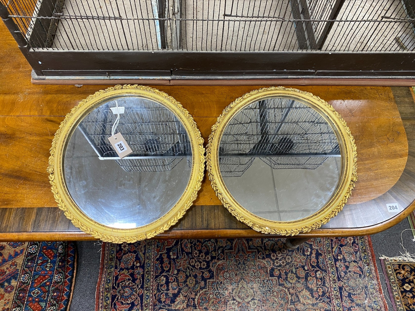 A pair of Victorian oval giltwood and composition wall mirrors, width 39cm, height 45cm